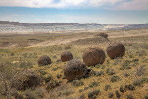 A cluster of six rock balls sitting in a desolate stretch of Kazakh desert.