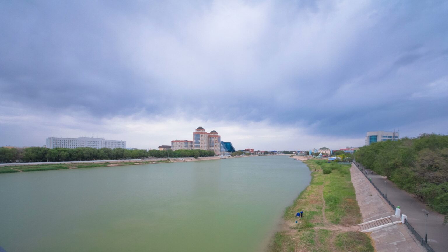 Wide shot of grey clouds over the Ural River in Atyrau.