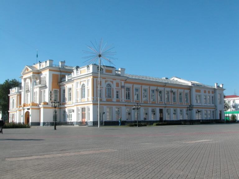 White and orange-coloured old government building in Oral.