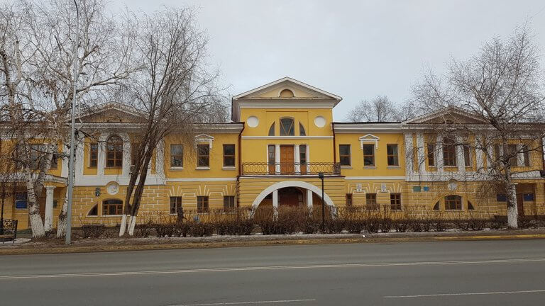 Yellow-colored Pushkin Museum exterior in Oral, Kazakhstan.